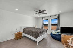 Bedroom featuring finished concrete flooring, ceiling fan, and recessed lighting