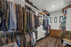 Walk in closet featuring dark wood-style floors
