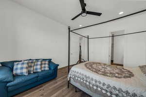 Bedroom featuring wood finished floors, ceiling fan, recessed lighting, and a closet