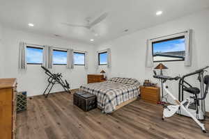 Bedroom with dark wood-style flooring, a ceiling fan, and recessed lighting