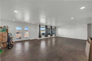 Spare room with concrete flooring, french doors, and recessed lighting