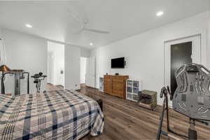 Bedroom with dark wood-type flooring, a ceiling fan, and recessed lighting