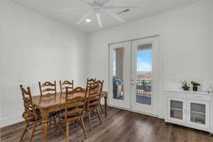 Dining area with french doors, dark wood-style flooring, recessed lighting, and a ceiling fan