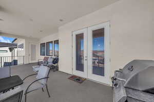 View of patio with french doors and area for grilling