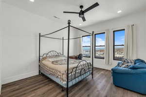 Bedroom with dark wood-style floors, a ceiling fan, and recessed lighting