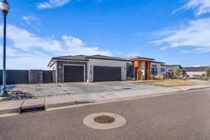 Prairie-style house with a garage, concrete driveway, and stucco siding