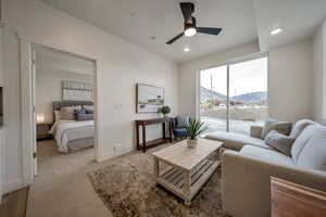 Carpeted living room with a mountain view, ceiling fan, and recessed lighting