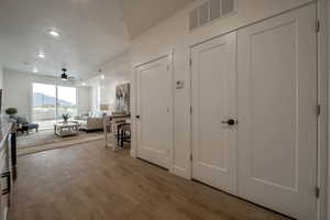 Entrance foyer with a mountain view, light wood-type flooring, ceiling fan, and recessed lighting