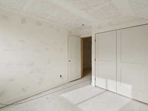 Unfurnished bedroom with a closet and concrete floors
