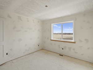 Spare room featuring a textured ceiling