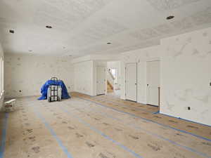 Additional living space featuring stairway and baseboards