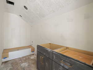 Bathroom featuring lofted ceiling and vanity