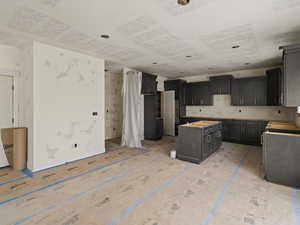 Kitchen featuring a kitchen island and dark cabinets