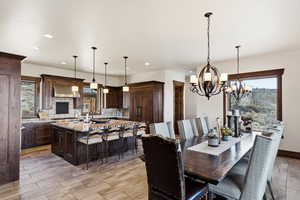Dining area featuring a chandelier and wood tiled floors