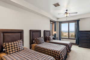 Bedroom with light colored carpet and ceiling fan