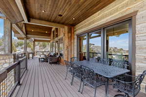 Wooden terrace featuring outdoor dining area