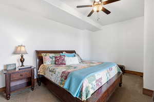 Bedroom featuring ceiling fan and carpet