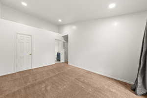 Unfurnished bedroom featuring ensuite bath, carpet floors, and recessed lighting