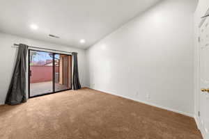 Unfurnished room with carpet floors, lofted ceiling, and recessed lighting