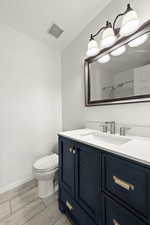 Full bathroom featuring vanity, wood finish floors, and a shower