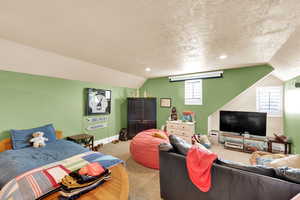 Carpeted bedroom with recessed lighting