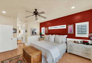 Bedroom with light wood finished floors, a ceiling fan, and recessed lighting