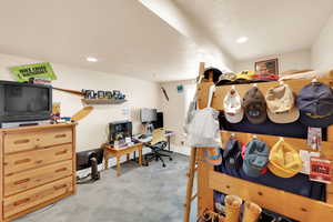 Interior space featuring a desk, light colored carpet, and recessed lighting