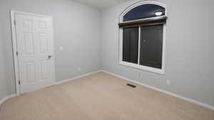 Unfurnished room featuring light colored carpet and baseboards