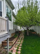 Fenced backyard featuring a garden