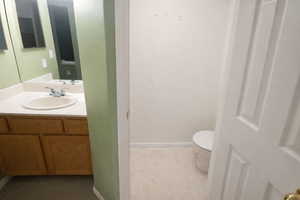 Half bathroom with toilet and vanity