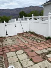View of patio featuring a mountain view and a gate