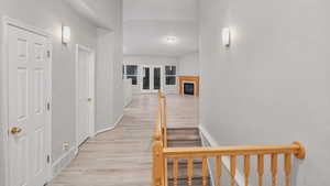 Corridor featuring light wood-style flooring