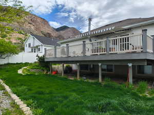 Back of house featuring a deck with mountain view