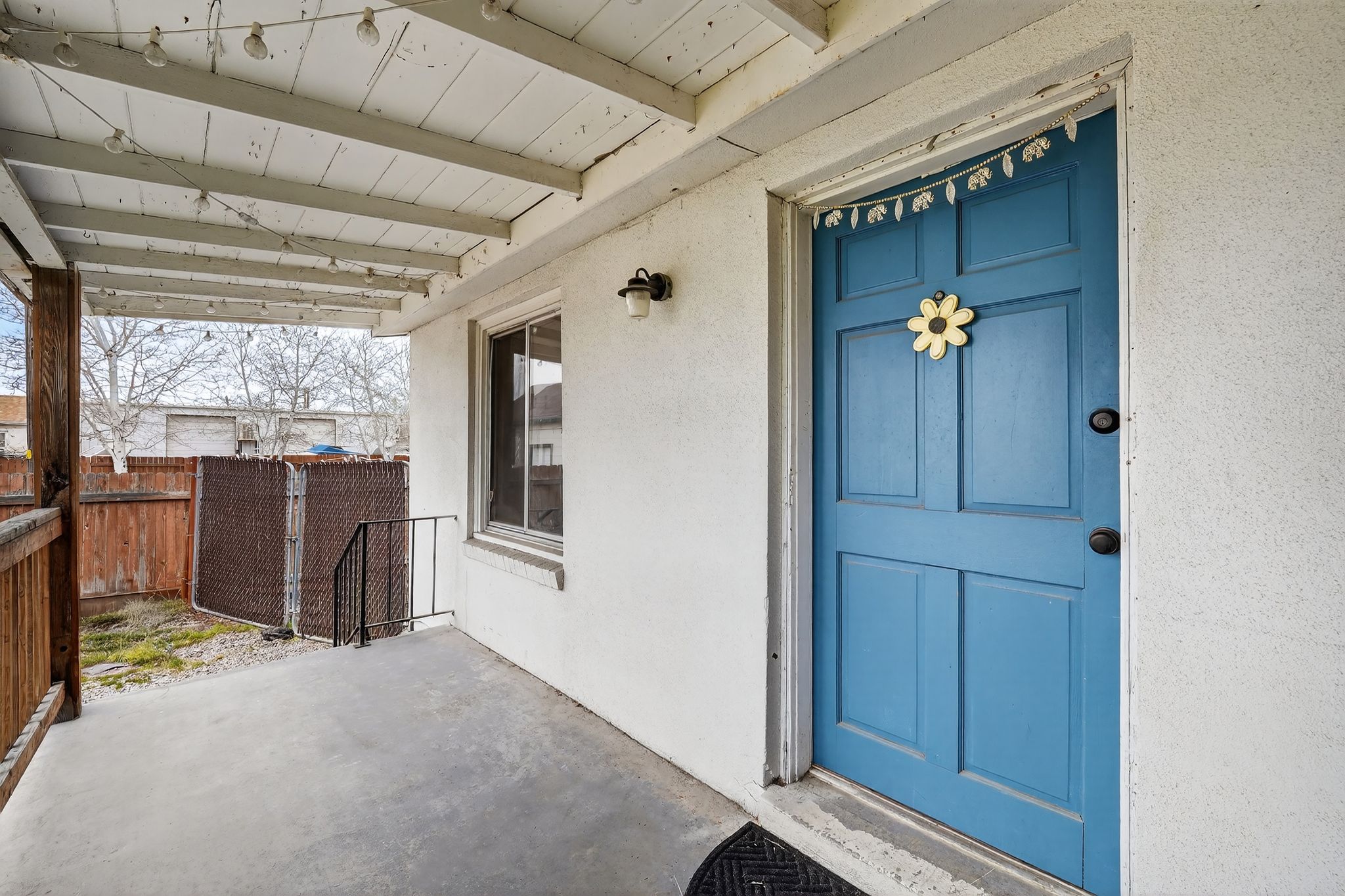 View of exterior entry featuring a patio and stucco siding