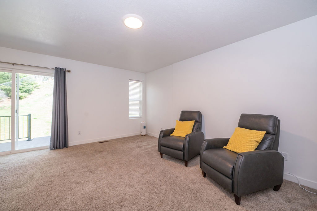 Sitting room featuring carpet flooring and healthy amount of natural light