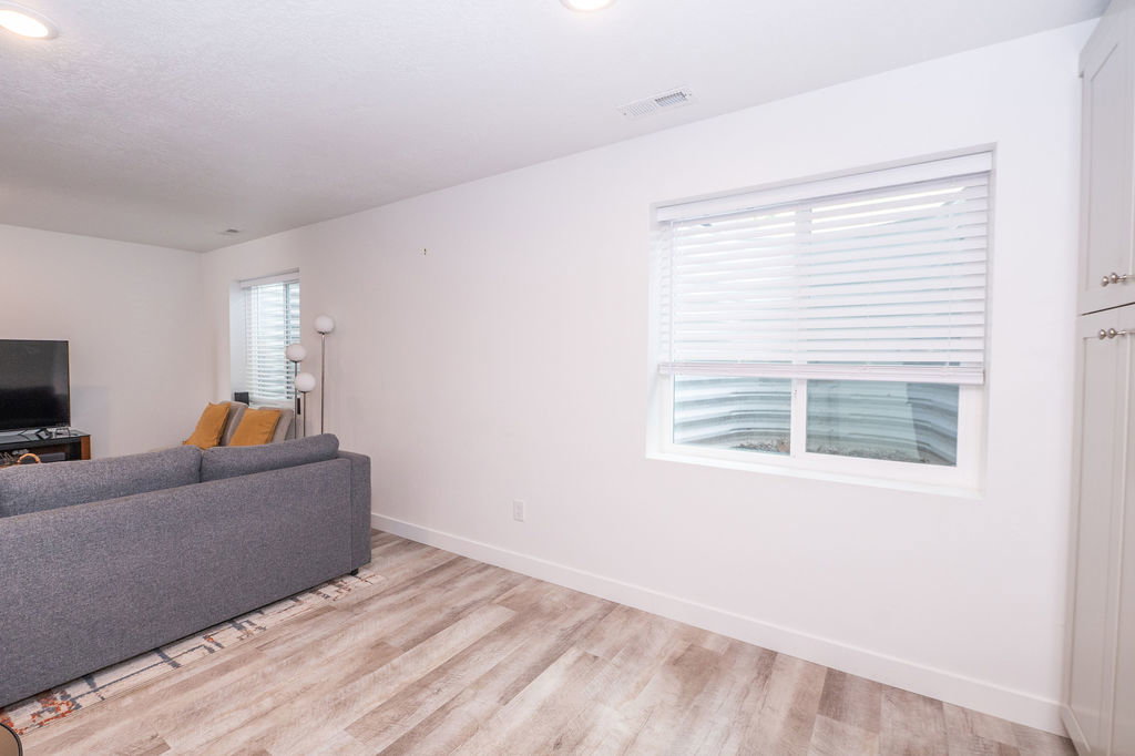 Living area featuring light wood finished floors and recessed lighting