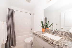 Bathroom with vanity and shower / bath combo with shower curtain
