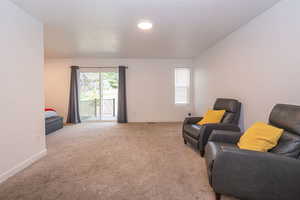 Sitting room with carpet and baseboards