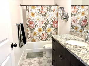 Bathroom with vanity and shower / bath combo