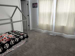 Carpeted bedroom with baseboards