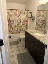 Bathroom with vanity and shower / bathtub combination with curtain