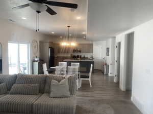 Living area with ceiling fan, recessed lighting, and dark wood-style flooring
