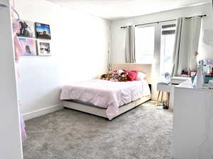 Bedroom featuring carpet flooring and a textured ceiling