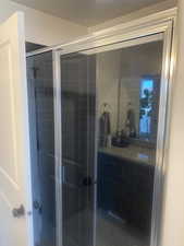 Full bathroom with a shower stall