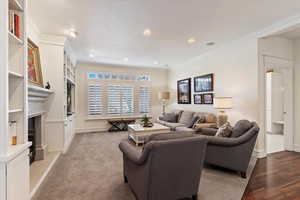Living area with ornamental molding and recessed lighting