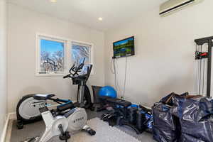 Workout area featuring a mini split for heating / cooling and recessed lighting