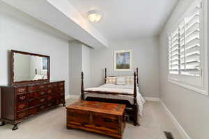 Bedroom featuring baseboards and light colored carpet