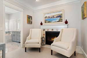 Sitting room with a tile fireplace and crown molding