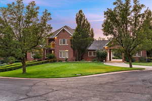 Traditional-style house with a lawn and brick siding