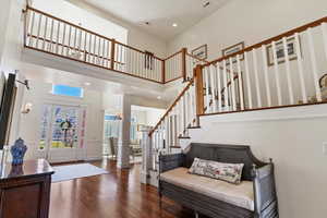 Entryway with recessed lighting, dark wood-style flooring, ornate columns, and a high ceiling